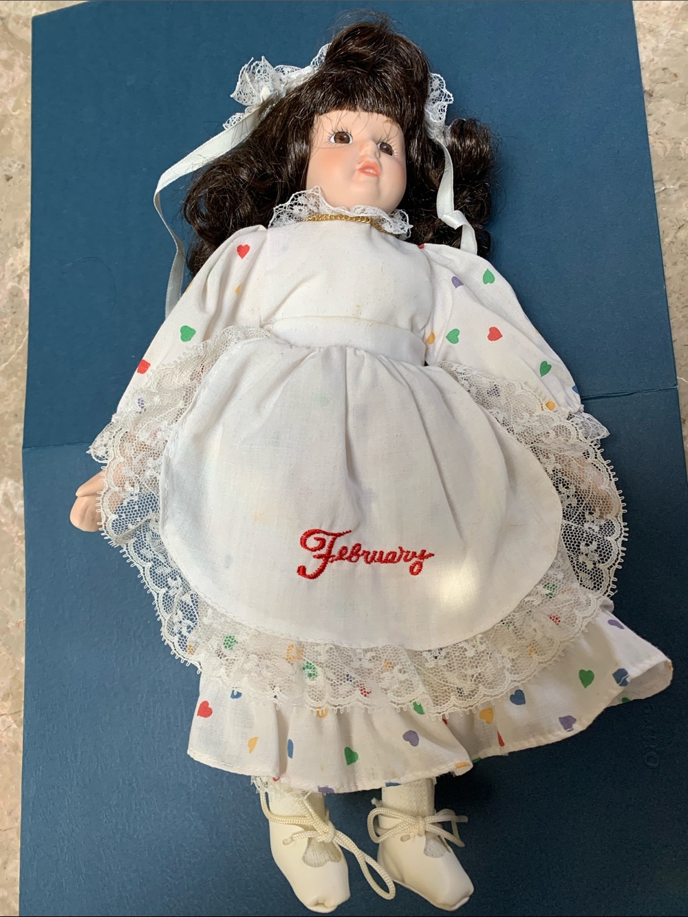 Cute February Porcelain Doll in White Dress w/Multicolor Hearts.Pre-Owned. 13”